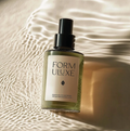 Bottle of Form Uluxe product on a textured beige surface