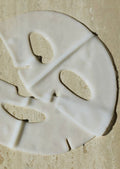 White ceramic plate with a decorative cutout design on a beige surface